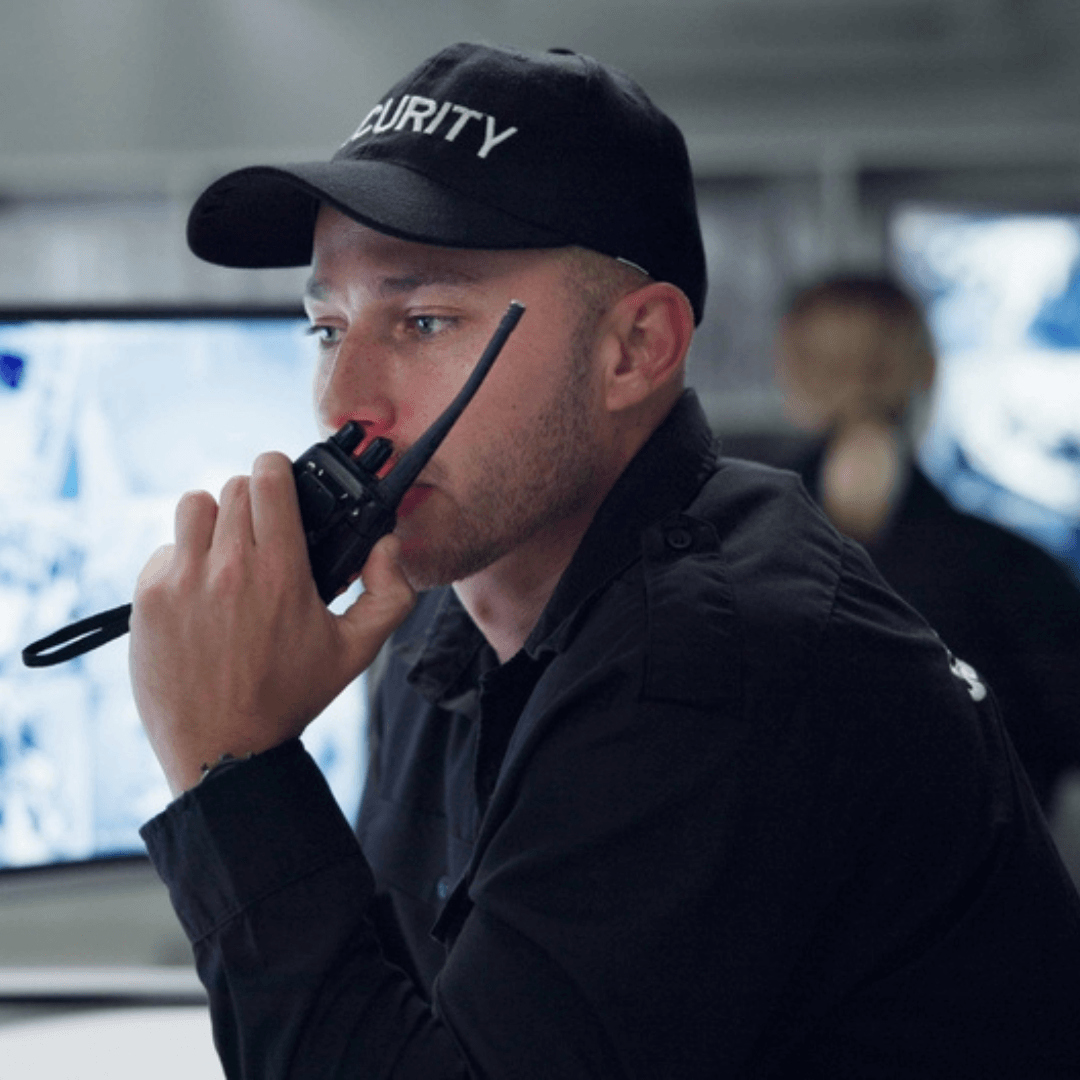 Security guard monitoring CCTV feeds